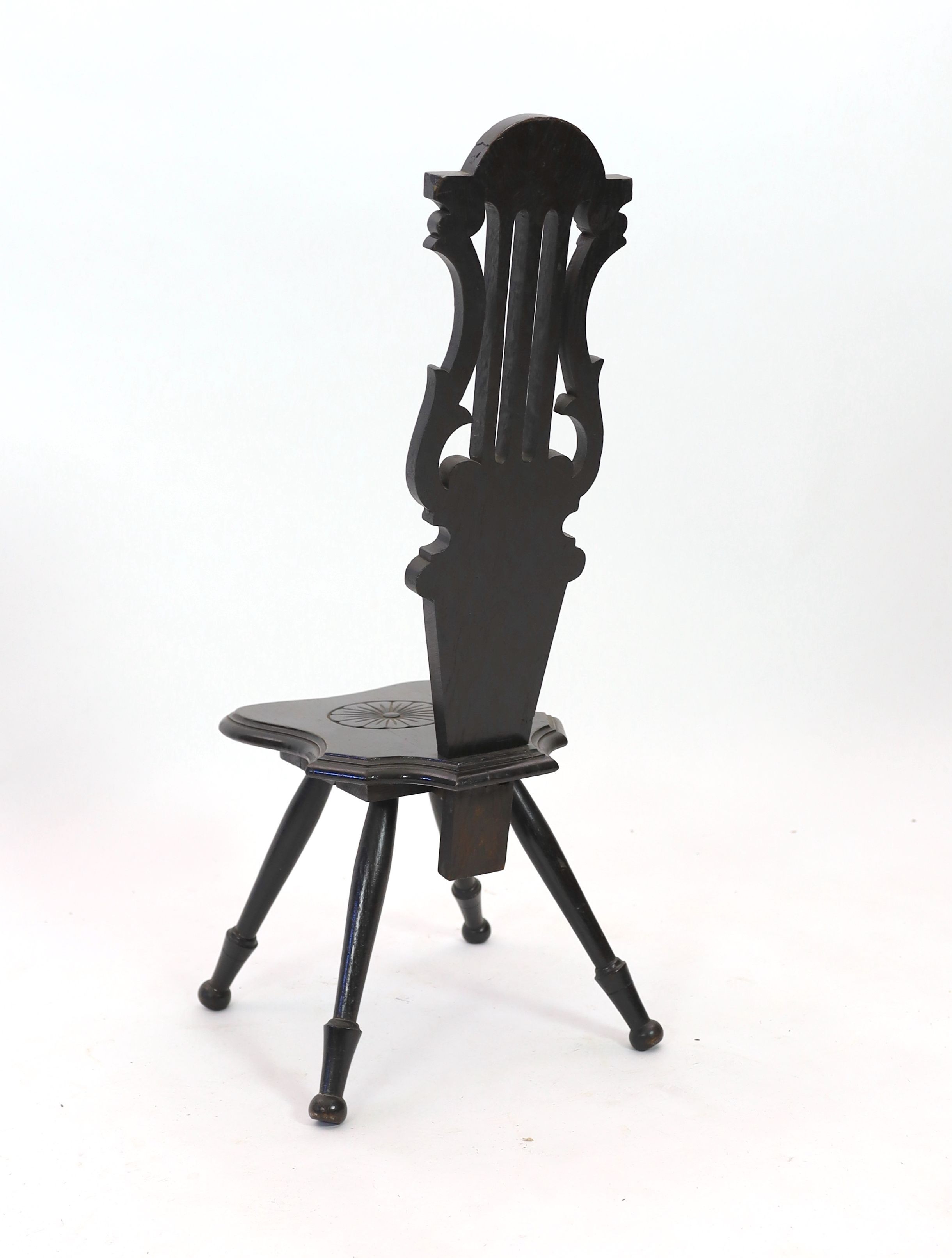 An early 20th century carved oak spinning chair, with lyre back, height 89cm